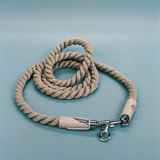 A coiled rope dog lead with a metal clip